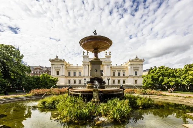 University building with fountain in the foreground. Photo.